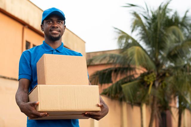 A delivery man holding boxes